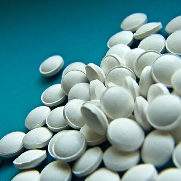 White pills against a blue background.